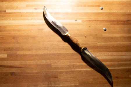 Knife on a wooden cutting board, top view. Selective focus.の写真素材
