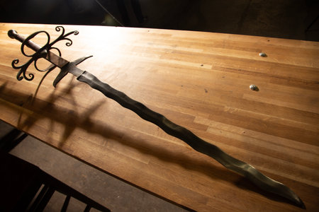 Medieval sword on a wooden table in a medieval castle, Polandの写真素材