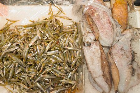 Seafood on ice in the fish market, closeup of photoの写真素材