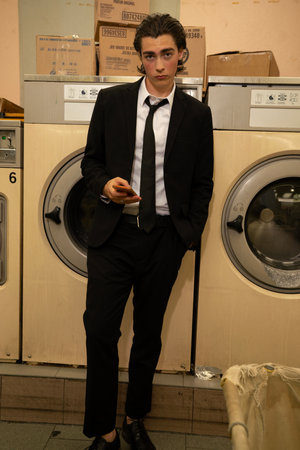 Fashionable man poses outside Gucci fashion show building for Milan Women's Fashion Week  in Milan.の写真素材