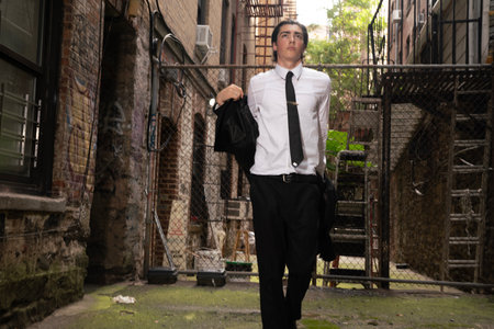 Portrait of a young business man walking through an abandoned building.の写真素材