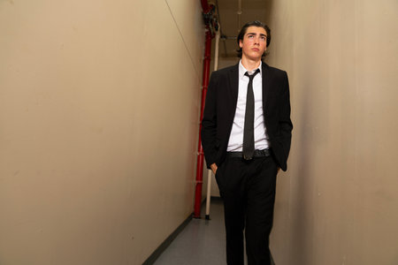 Handsome young man in a business suit standing in a corridorの写真素材