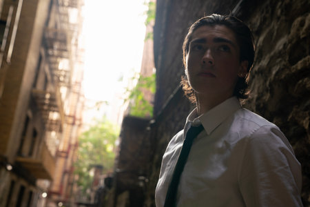 Young man in a white shirt and tie in the streets of the cityの写真素材