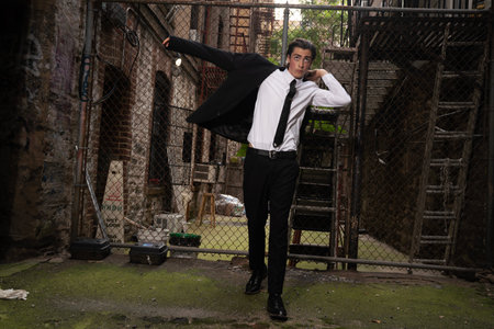 Portrait of a young business man standing in an abandoned building.の写真素材