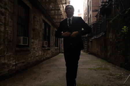 Portrait of a confident businessman standing with arms crossed in an urban environmentの写真素材