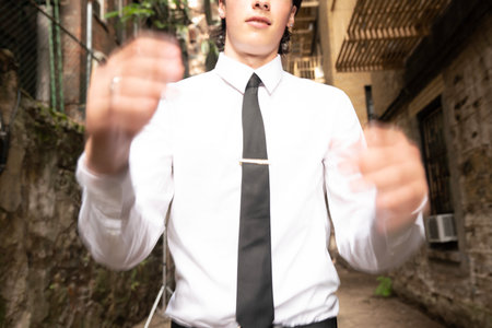 Businessman in the city with both hands outstretched to the cameraの写真素材