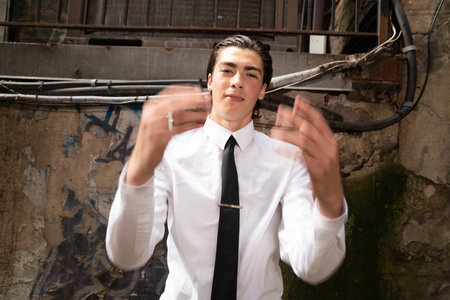 Young businessman in a white shirt and tie in an abandoned building.の写真素材