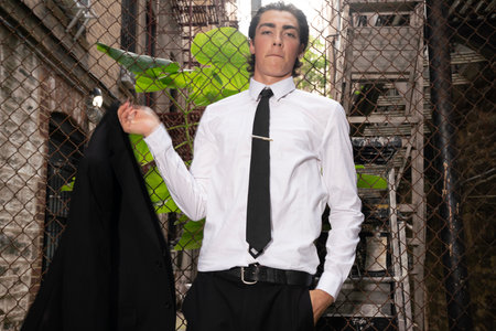Portrait of a young businessman in a business suit and tie standing in an abandoned buildingの写真素材