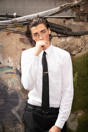 Handsome young man in shirt and tie posing in an urban environmentの写真素材