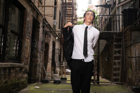 Portrait of a handsome young man in an urban setting with a black tieの写真素材