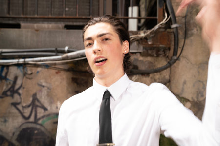 Portrait of a young person in a white shirt and black tieの写真素材