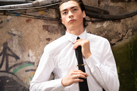 Portrait of a handsome young man in white shirt and black tieの写真素材