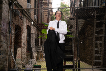 Businessman in white shirt and black tie posing in an urban contextの写真素材