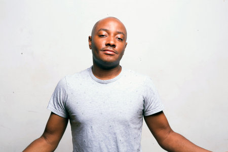 young handsome african american man in casual clothes posing emotional on white background, lifestyle people conceptの写真素材