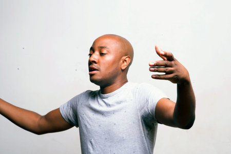 Portrait of a young bald man in a white T-shirtの写真素材