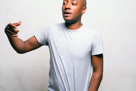 young handsome african american man in white t-shirt posing emotional isolated on white background, lifestyle people conceptの写真素材