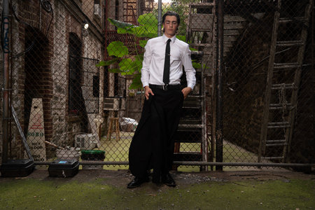 Young handsome businessman standing in an abandoned building with his hands in his pocketsの写真素材