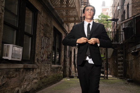 Portrait of a young business man in a black suit and tieの写真素材