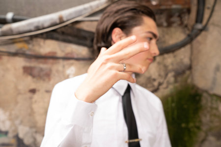 Young man with short hair in a white shirt and black tie.の写真素材