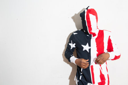 African american man in a hoodie with stars and stripes.の写真素材
