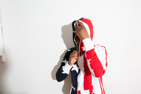 african american man wearing red and white clothes and headphonesの写真素材