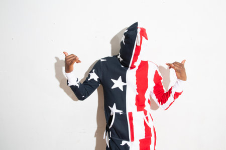 Young man in a costume of the American flag on a white backgroundの写真素材