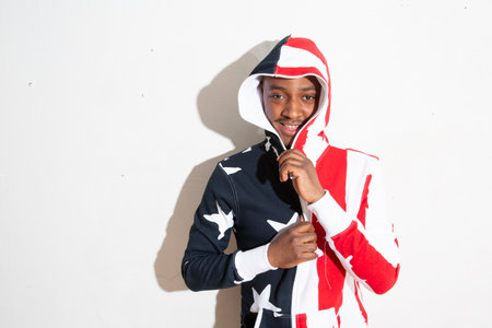 Portrait of a young asian man wearing american flag costumeの写真素材