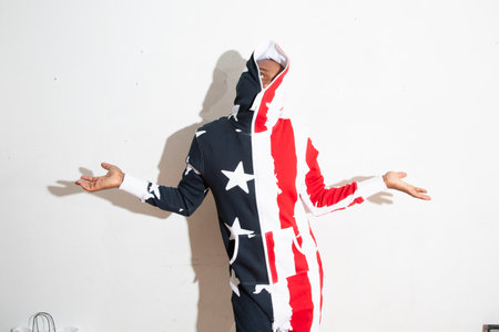 Funny man in a costume of the American flag on a white backgroundの写真素材