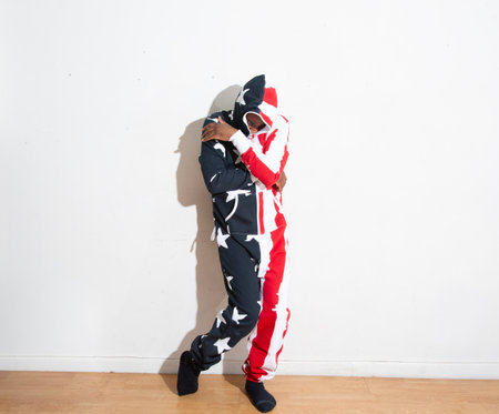 African american man dressed as joker against a white wall.の写真素材