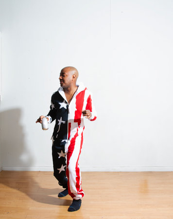 African american man with an American flag on a white background.の写真素材