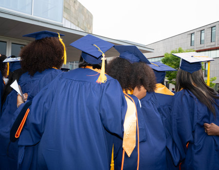 Rear view of a group of diverse students wearing graduation gownsの写真素材