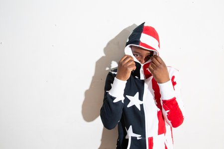 African american teenage boy in a red and white jacket and hatの写真素材