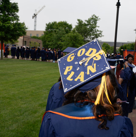 A shot of a graduate wearing a hat and gown during a graduation ceremony.の写真素材