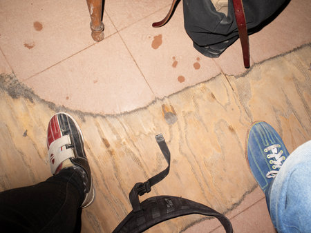 Close-up of feet and shoes on the floor in the roomの写真素材