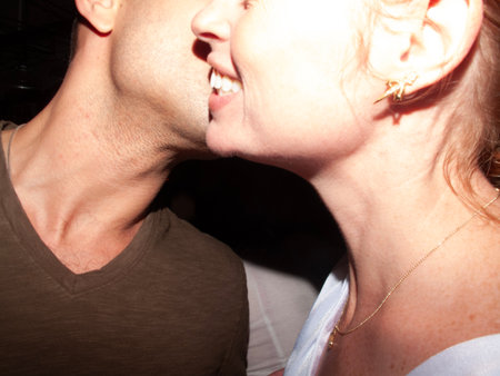Close up of a couple kissing in a nightclub, shallow depth of fieldの写真素材