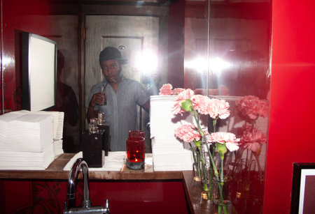 Handsome african american man in a bar interior.の写真素材