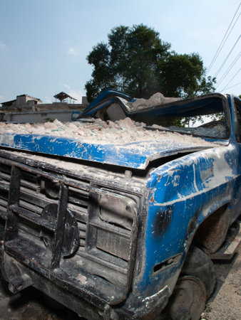 Old truck in the middle of the road with dust and dirt.の写真素材
