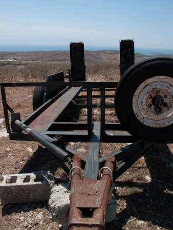 Abandoned military equipment on the background of the sea and mountains