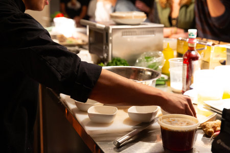 Chef preparing food in the kitchen, close-up of hands