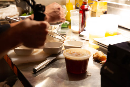 Chef preparing a dish in a restaurant kitchen.の写真素材