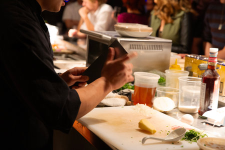 Hands of a professional chef preparing a meal in a restaurant.の写真素材