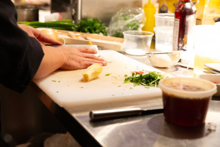 Chef preparing a meal in a restaurant kitchen, close-upの写真素材