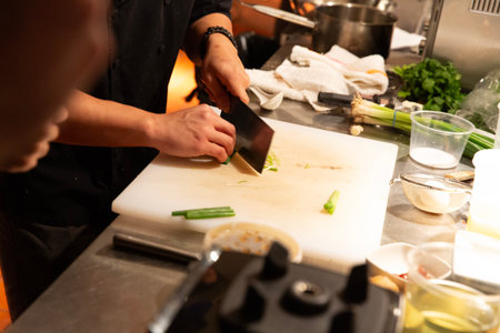 Chef cutting vegetables in a restaurant kitchen. Selective focus.の写真素材