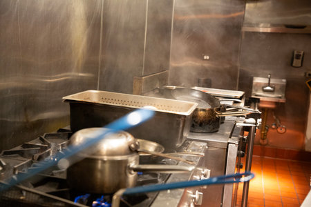 pot with boiling water on the gas stove in the kitchen of the restaurantの写真素材