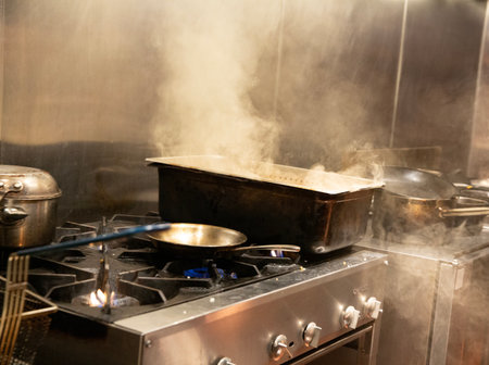 pot with boiling water on the gas stove in the kitchen of a restaurantの写真素材