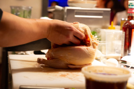 how to prepare a chicken in the kitchen, closeup of handsの写真素材