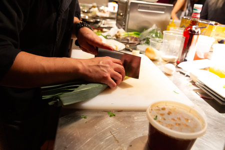 Chef cutting a piece of vegetables for cooking in the kitchen.の写真素材