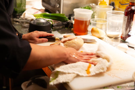 Chef preparing chicken fillet for cooking in a restaurant kitchen.の写真素材