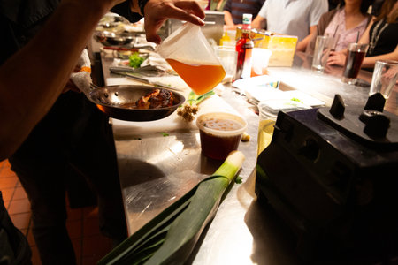chef preparing food in the kitchen of a restaurant, close up