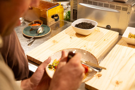 Chef preparing food in the kitchen at restaurant. Chef decorating dish.の写真素材
